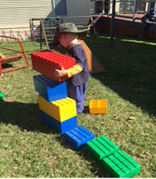 child using large lego building blocks